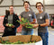 Founders of Buddha Brands holding corns in front of a box of full of corns - on the top left logo says " one percent for the planet"