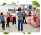 A group of Buddha Brands team members stand together in a factory plant, engaged in a discussion.